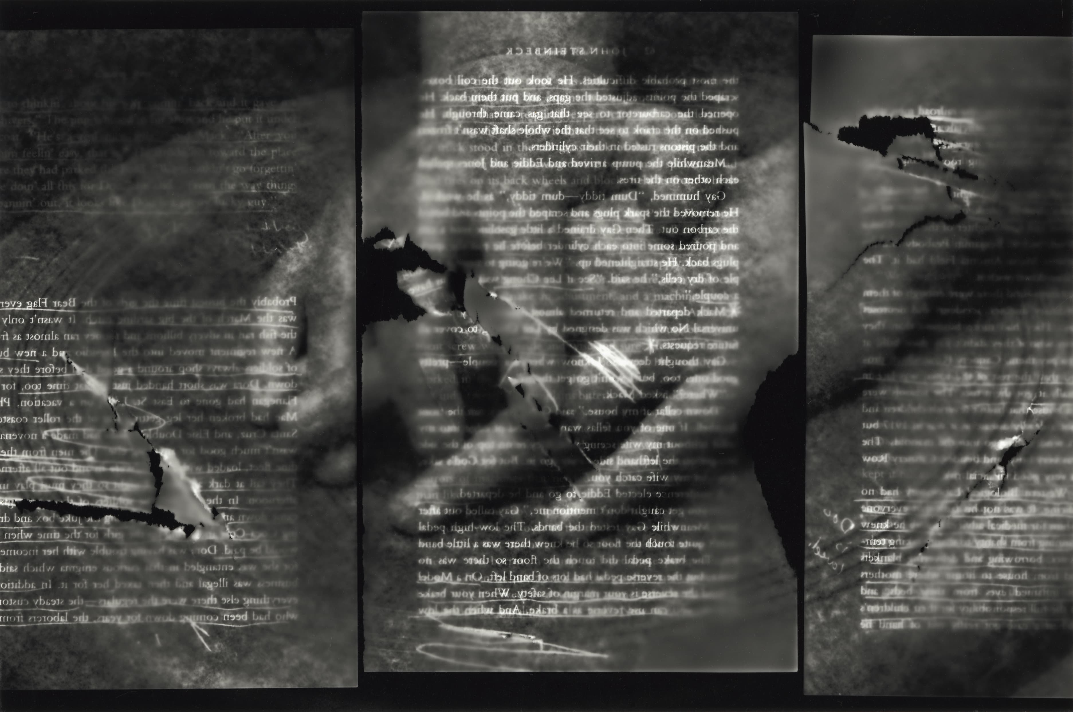 Black and white film photograph of torn book pages laid over folded hands