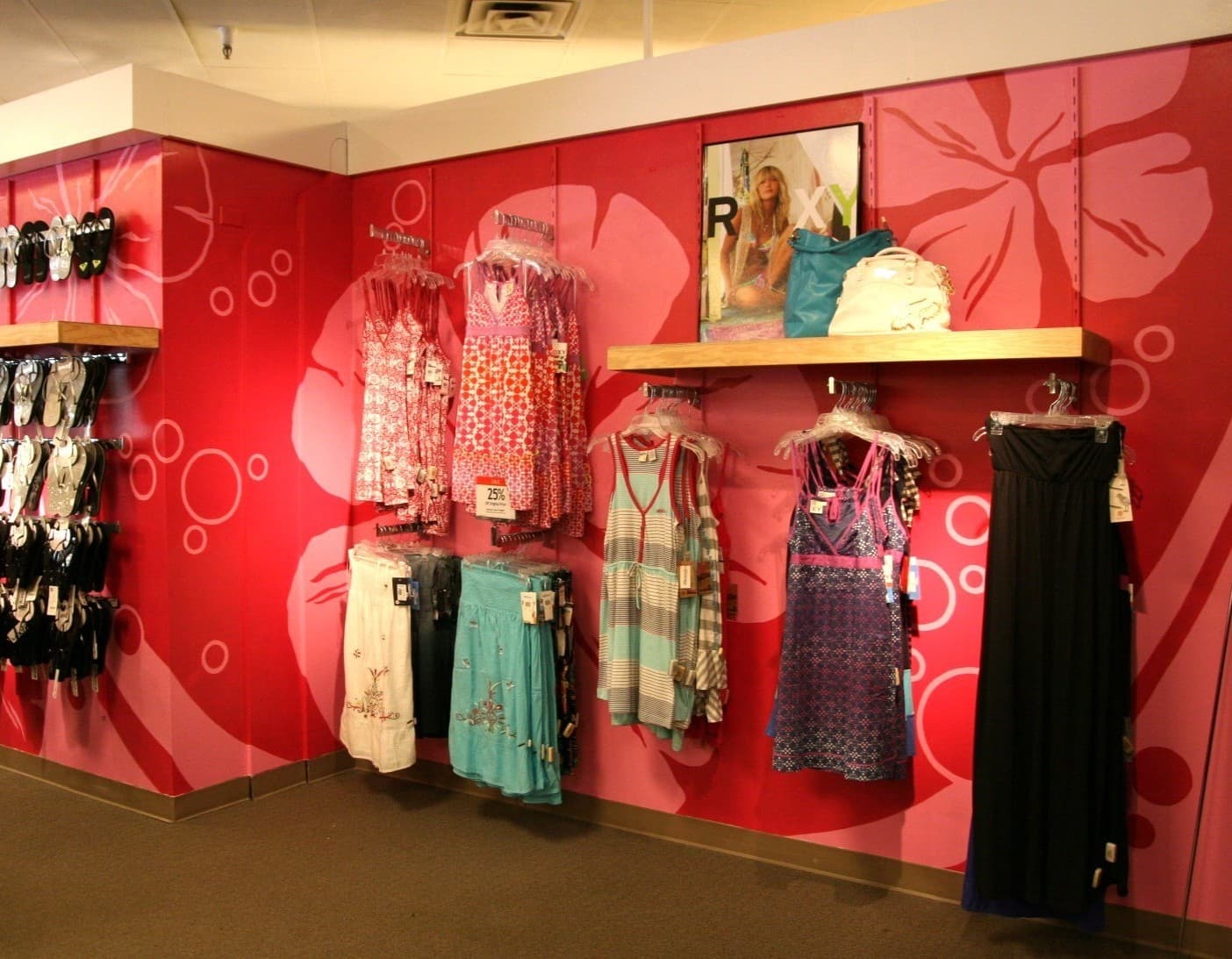 A photograph of a Macy's Juniors department with a brightly painted mural